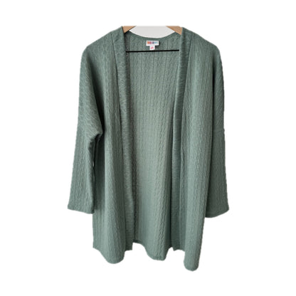 LuLaRoe Connie Lightweight Overlay in Solid Eucalyptus Green featuring a lightweight cable knit texture, open front cardigan, relaxed fit, and long sleeves layered over a white ribbed tank.