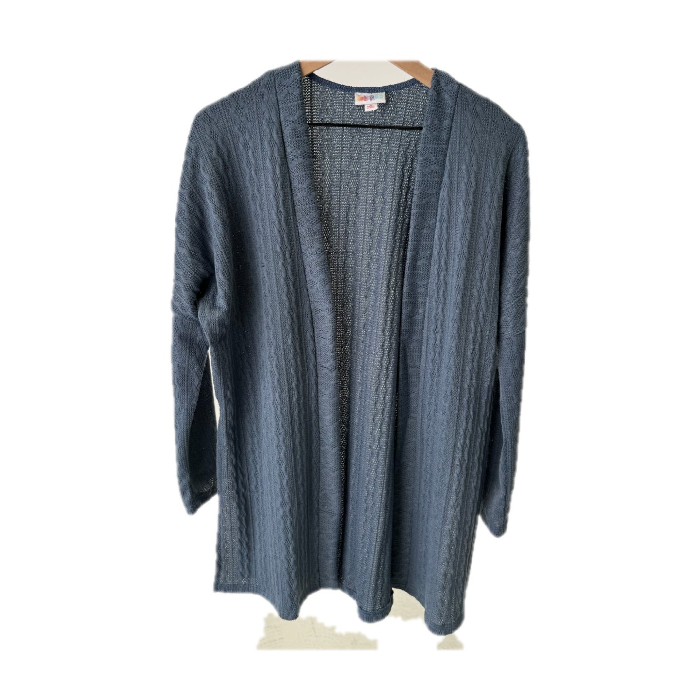 LuLaRoe Connie Lightweight Overlay in Solid Slate Blue featuring a lightweight cable knit texture, open front cardigan, relaxed fit, and long sleeves layered over a white ribbed tank.