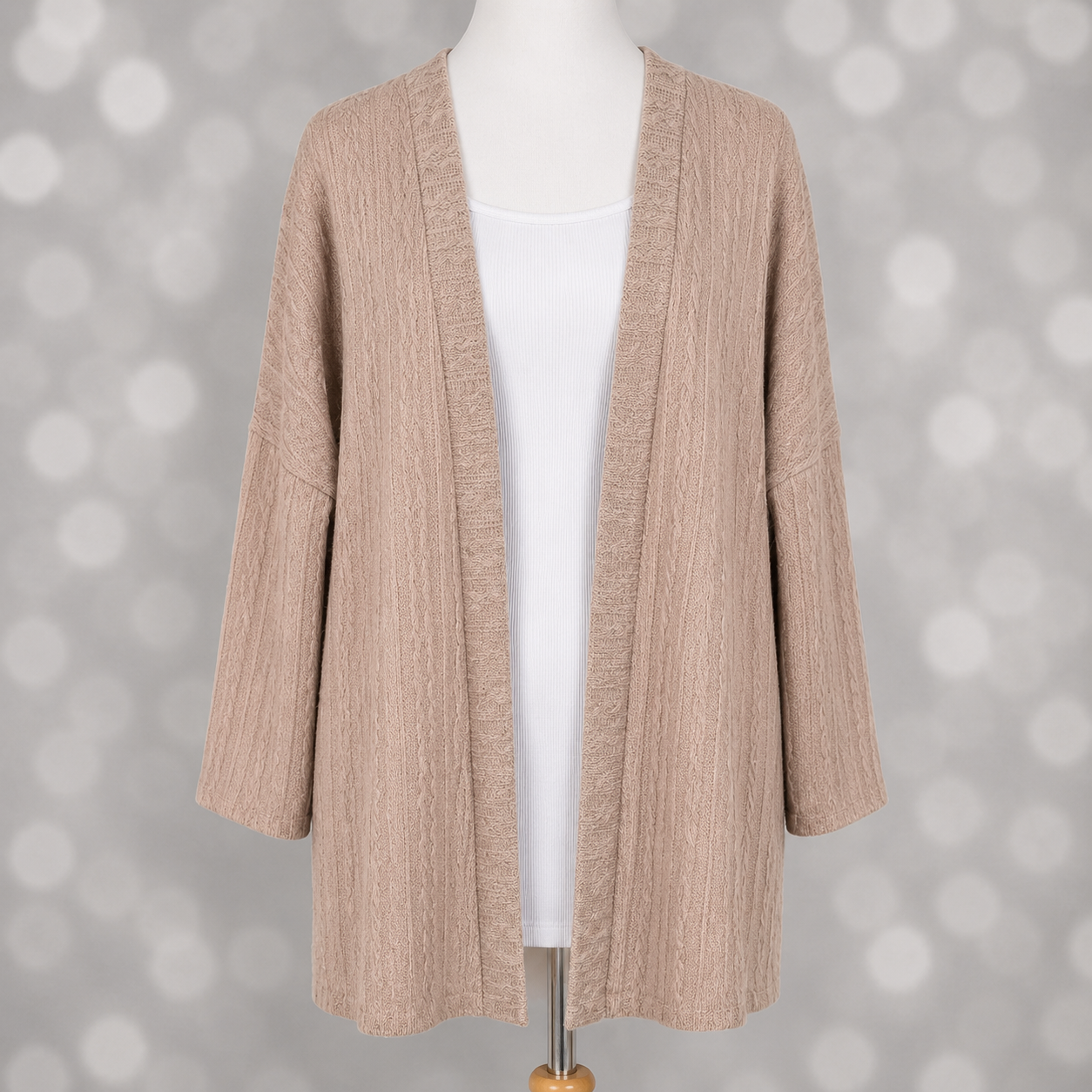LuLaRoe Connie Lightweight Overlay in Solid Soft Blush featuring a lightweight cable knit texture, open front cardigan, relaxed fit, and long sleeves layered over a white ribbed tank.