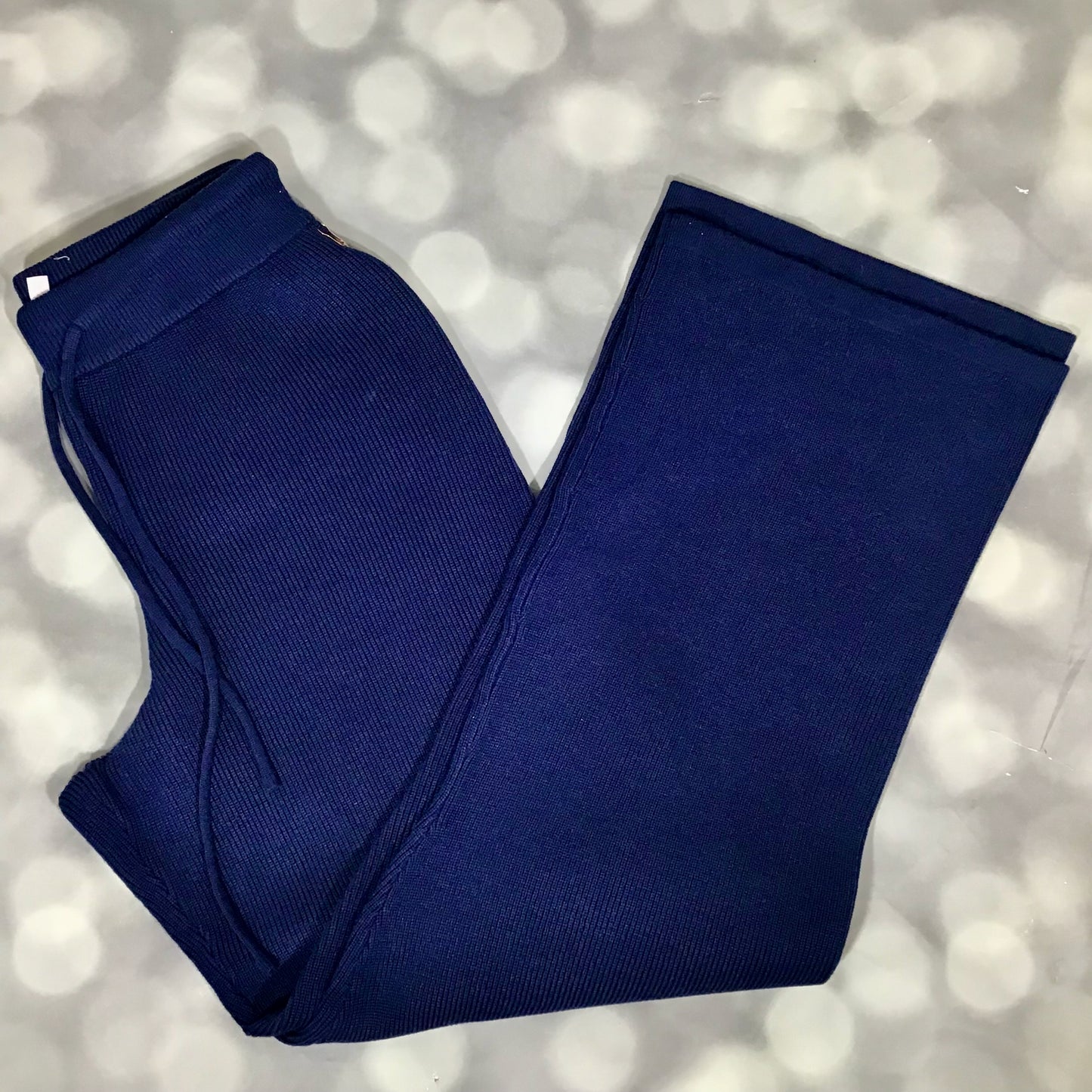 Folded blue pants on a light gray background