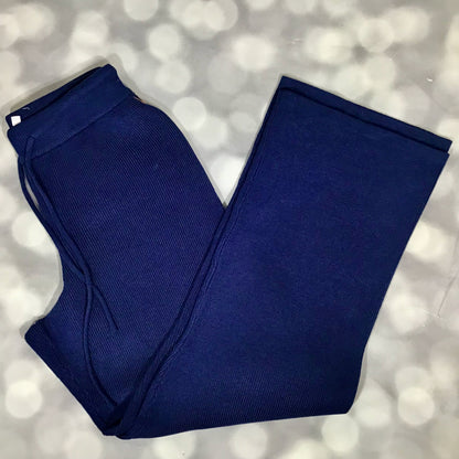 Folded blue pants on a light gray background