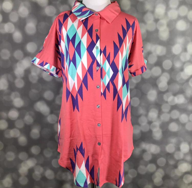 Front view of mannequin wearing LuLaRoe Charlie Button Up Shirt in coral fabric with purple, teal, and white jumbo Aztec print and short sleeves