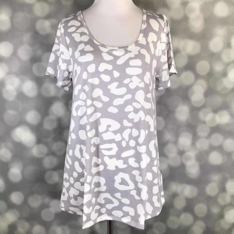 Front view of LuLaRoe Classic T displayed on mannequin in soft grey with bold white cheetah print, short sleeves, and relaxed curved hem silhouette