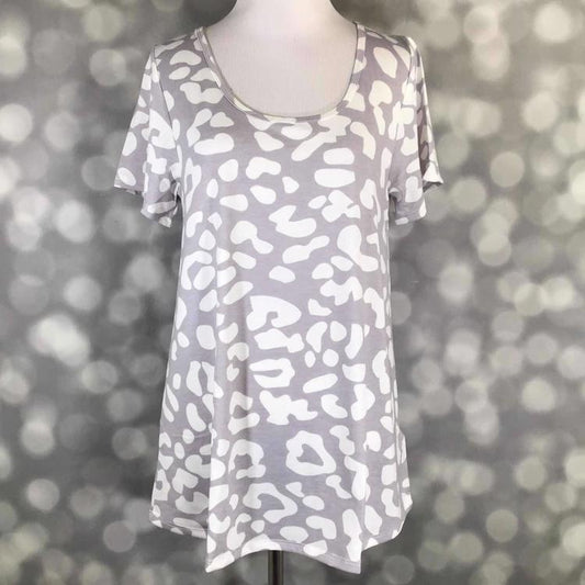 Front view of LuLaRoe Classic T displayed on mannequin in soft grey with bold white cheetah print, short sleeves, and relaxed curved hem silhouette