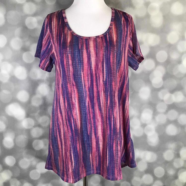 Front view of LuLaRoe Classic T on mannequin in mauve and blue texture print with short sleeves, scoop neckline, and slightly flared hemline