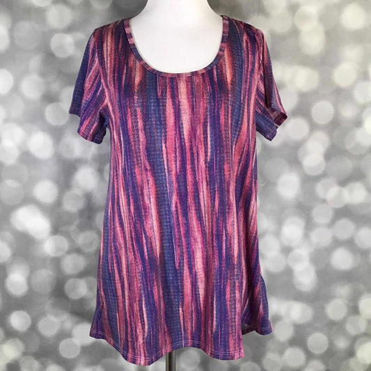 Front view of LuLaRoe Classic T on mannequin in mauve and blue texture print with short sleeves, scoop neckline, and slightly flared hemline