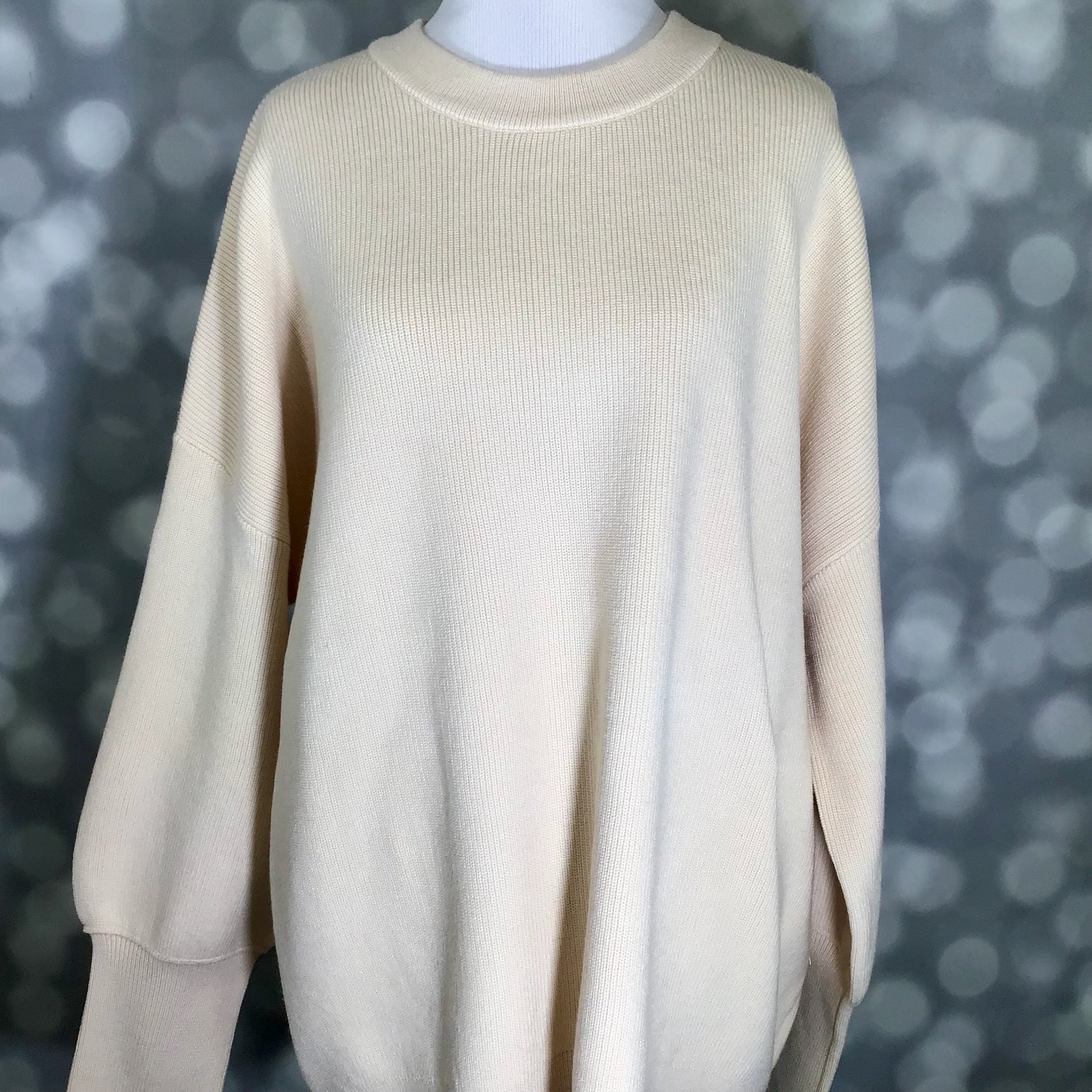 LuLaRoe Cozy Chris Top in a solid warm sandstone beige color, displayed on a mannequin with a relaxed oversized fit, drop shoulders, long sleeves, and a soft micro rib knit texture