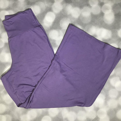 LuLaRoe Essential Wide Leg Pant in solid violet purple featuring relaxed wide-leg silhouette and comfortable waistband on a blurred gray background