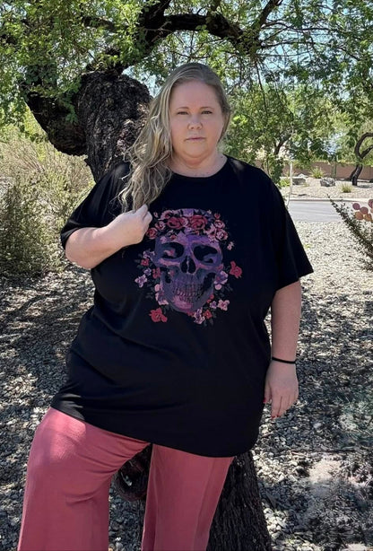 Person wearing a black t-shirt with a colorful design outdoors
