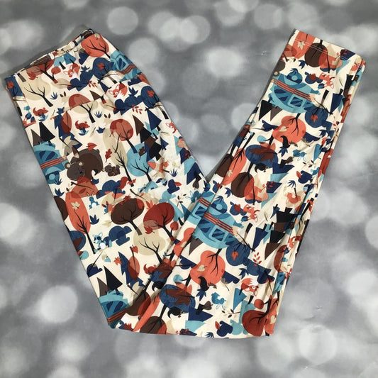 Flat lay of LuLaRoe leggings in cream background with forest critters print including foxes, bears, trees, and leaves