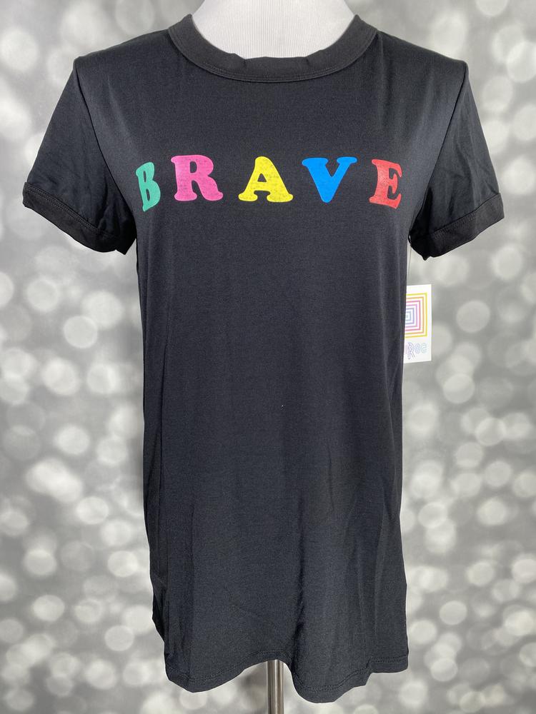 Women’s Liv graphic tee in black with rainbow “Brave” lettering, short sleeves, and relaxed fit on a mannequin against a gray background