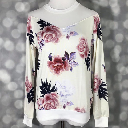 LuLaRoe Lizzy sweater in white with blush-pink floral print and sheer white mesh yoke, lightweight hacci fabric with ribbed details on a mannequin against a blurred background