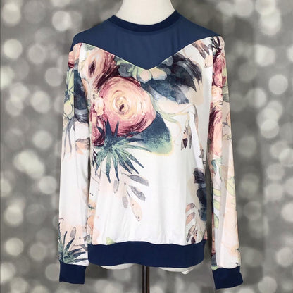 LuLaRoe Lizzy sweater in watercolor floral print with navy mesh yoke, featuring ribbed cuffs and a lightweight hacci fabric on a mannequin against a gray background