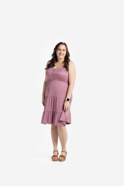 Woman modeling the LuLaRoe Amanda Dress in Solid Dusty Mauve, featuring a muted mauve pink sleeveless tiered midi silhouette with a relaxed feminine fit photographed against a light neutral studio background.