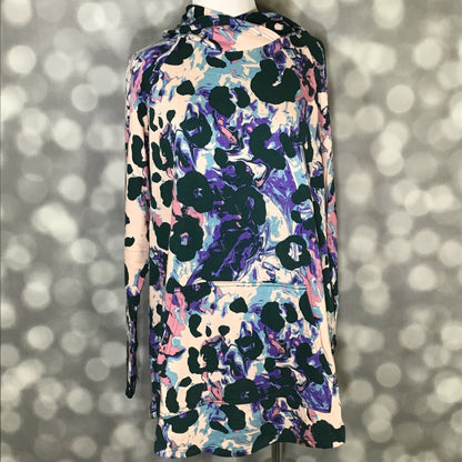 LuLaRoe Amber Hoodie in Amethyst Drift Abstract featuring a blush base with purple, blue, teal, and dark green abstract painterly print, showing long sleeves, hood, and kangaroo pocket with a front view on mannequin against a blurred background.