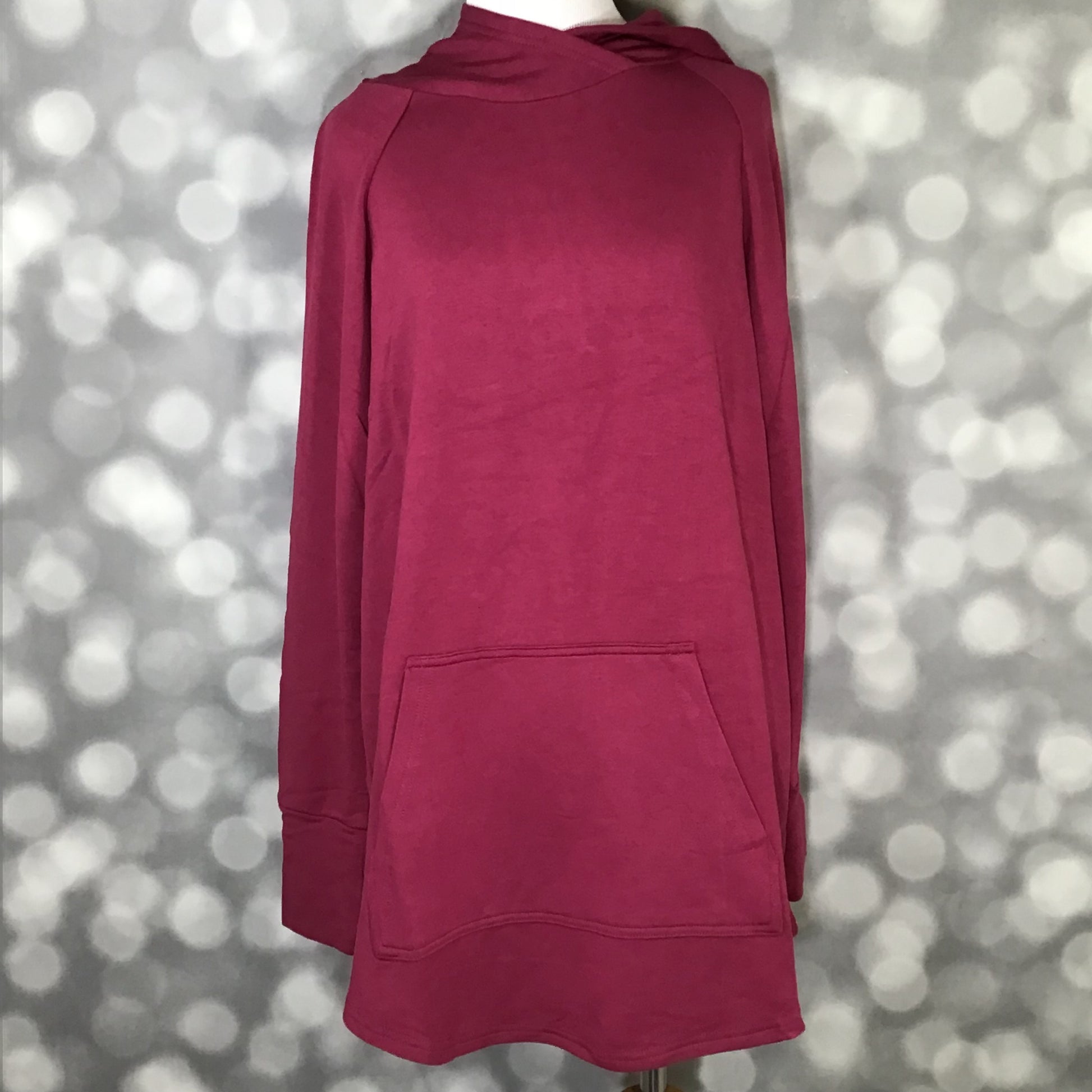 LuLaRoe Amber Hoodie in Solid Bright Raspberry Rose with relaxed fit, long sleeves, hood, and kangaroo pocket, front view on mannequin against a blurred background
