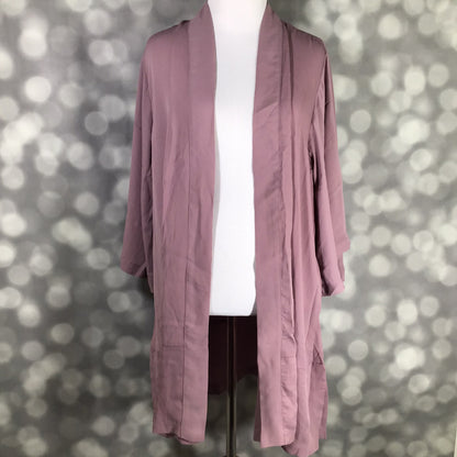 Mauve cardigan on a mannequin against a blurred background