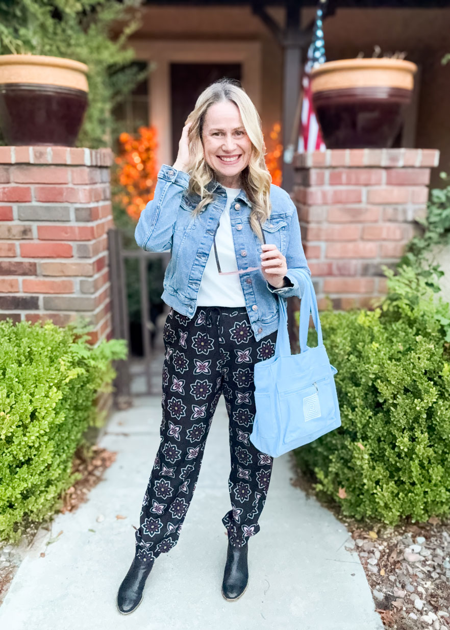 LuLaRoe Boyfriend Joggers in a black boho floral geometric print worn by a model. Relaxed-fit joggers with drawstring waist, cuffed ankles, and soft Ponte fabric.