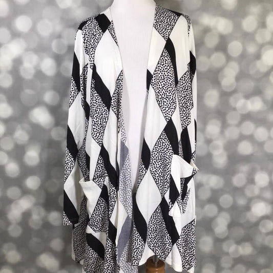 LuLaRoe Caroline cardigan in black and white diamond print with dotted accents and pockets, mid-thigh length.
