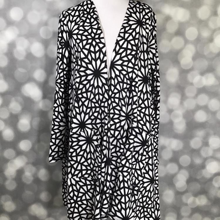 LuLaRoe Caroline Cardigan in black and white geometric starburst mosaic print. Mid-thigh length, open-front cardigan with pockets