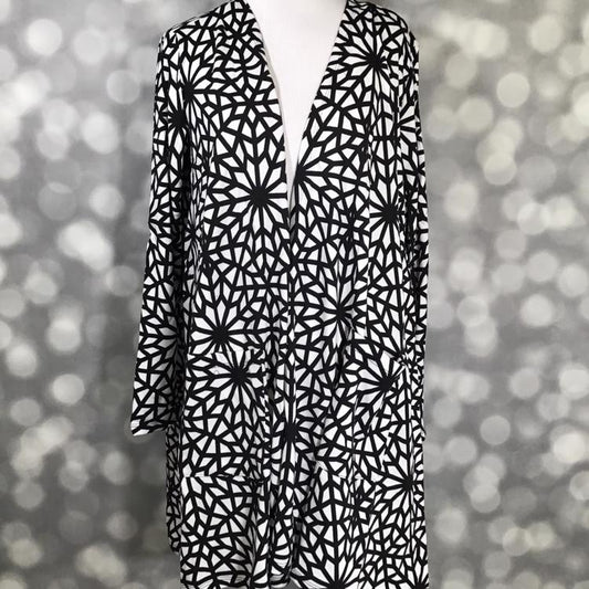 LuLaRoe Caroline Cardigan in black and white geometric starburst mosaic print. Mid-thigh length, open-front cardigan with pockets