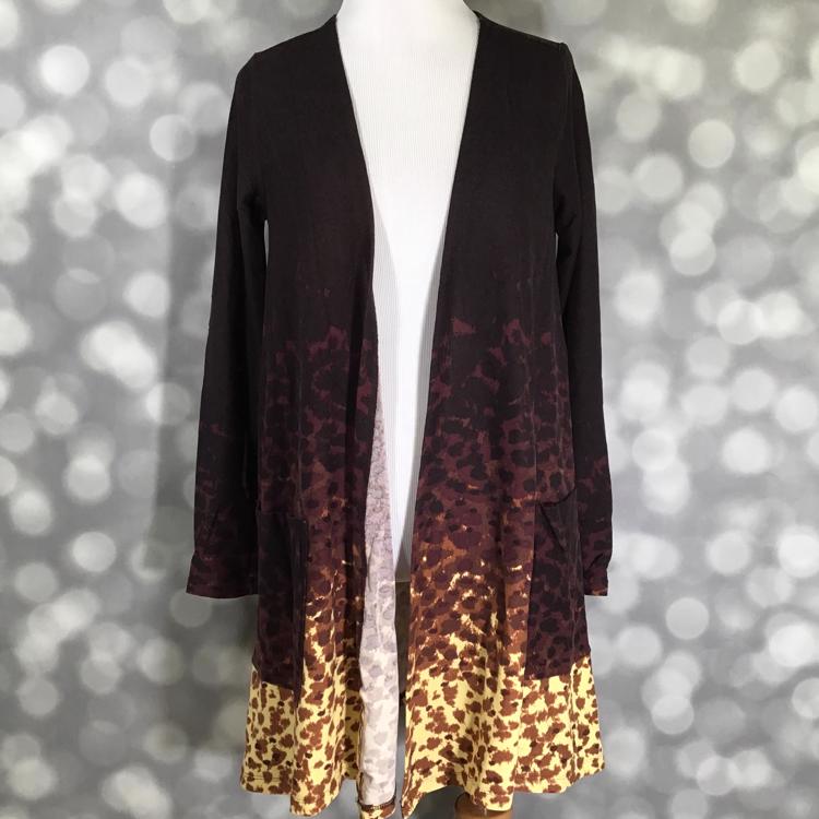LuLaRoe Caroline cardigan in brown and yellow ombre leopard print with open front and pockets.