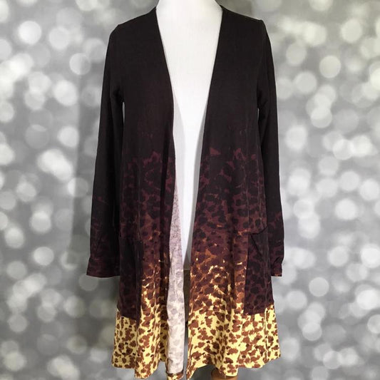 LuLaRoe Caroline cardigan in brown and yellow ombre leopard print with open front and pockets.