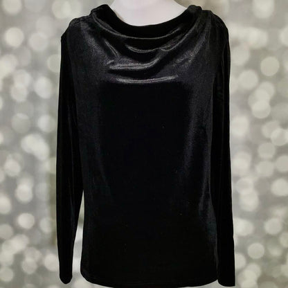 A black long-sleeve top with a draped, cowl-like neckline, displayed on a mannequin against a soft, out-of-focus bokeh background.