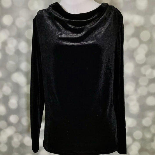 A black long-sleeve top with a draped, cowl-like neckline, displayed on a mannequin against a soft, out-of-focus bokeh background.