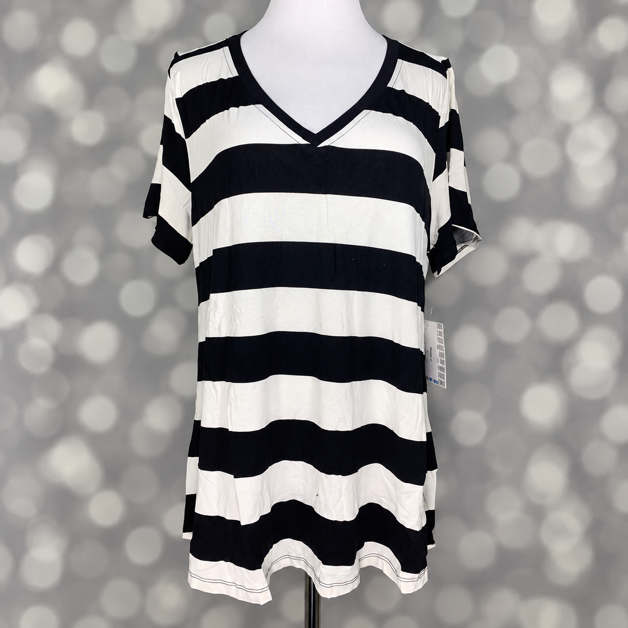 LuLaRoe Christy T in Black & Ivory Bold Stripe, featuring wide black and ivory horizontal stripes, a flattering V-neckline, short sleeves and a relaxed fit.