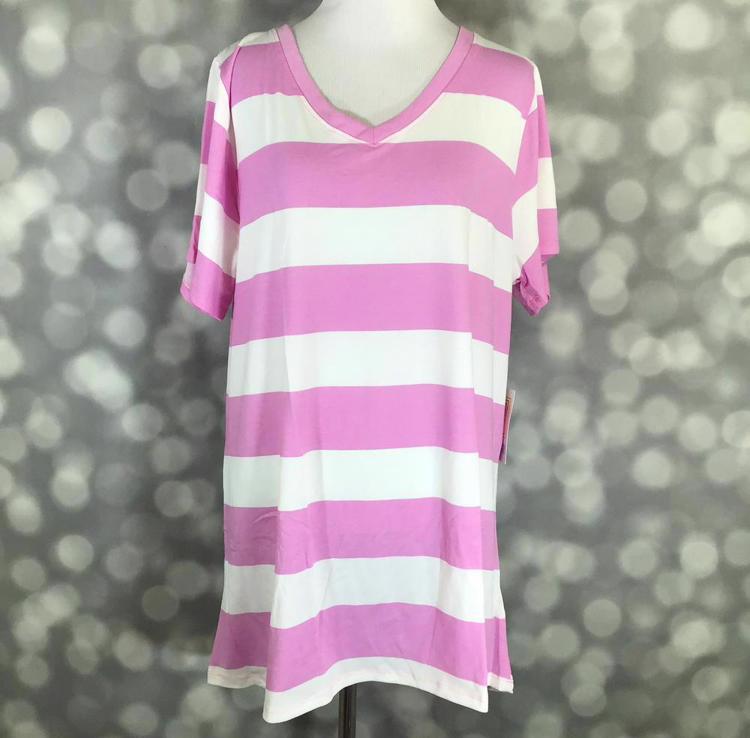 Pink and white striped LuLaRoe Christy T featuring bold horizontal bubblegum pink stripes, short sleeves, and a V-neckline displayed on a mannequin against a silver bokeh background.