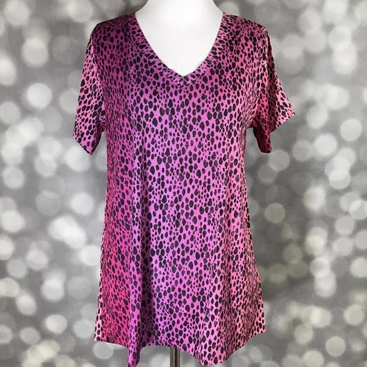 LuLaRoe Christy T featuring a vibrant fuchsia pink gradient animal-inspired black spotted print with a relaxed V-neck swing silhouette displayed on a mannequin against a silver bokeh backdrop.