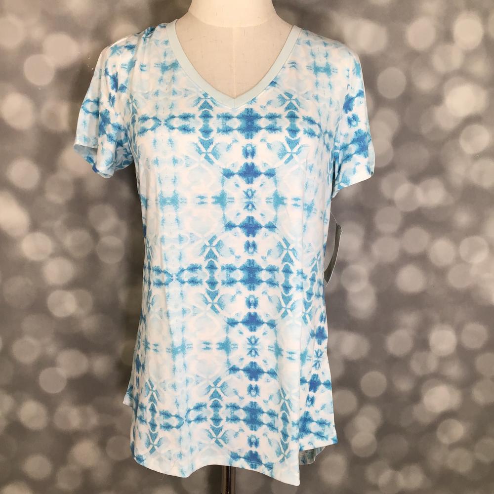 LuLaRoe Christy T in Ivory & Sky Blue Geometric Tie-Dye, featuring an airy ivory and sky blue geometric tie-dye pattern, a flattering V-neckline, short sleeves and a relaxed fit.