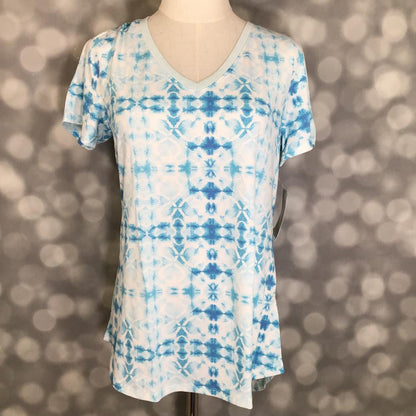 LuLaRoe Christy T in Ivory & Sky Blue Geometric Tie-Dye, featuring an airy ivory and sky blue geometric tie-dye pattern, a flattering V-neckline, short sleeves and a relaxed fit.