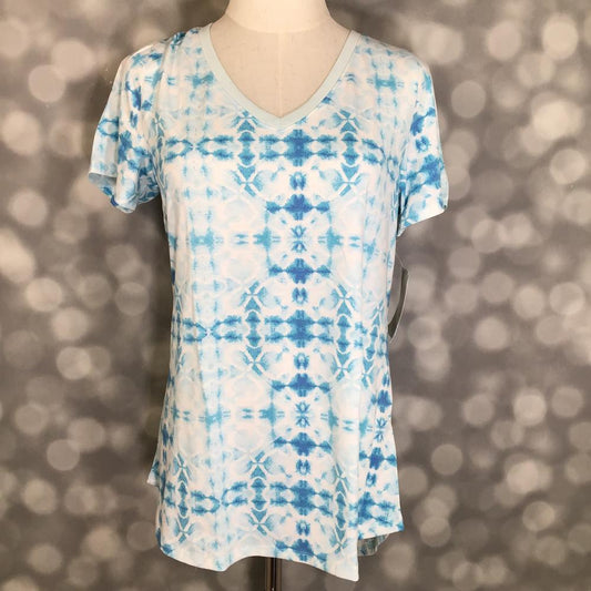 LuLaRoe Christy T in Ivory & Sky Blue Geometric Tie-Dye, featuring an airy ivory and sky blue geometric tie-dye pattern, a flattering V-neckline, short sleeves and a relaxed fit.