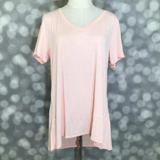 LuLaRoe Christy T in soft blush pink featuring a relaxed V-neck swing silhouette displayed on a mannequin against a silver bokeh background.
