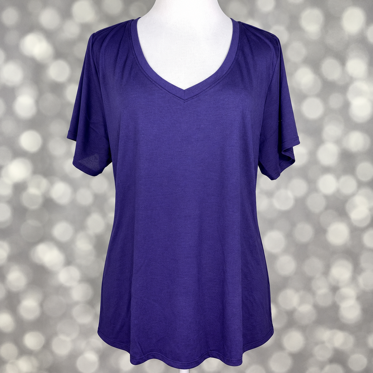 LuLaRoe Christy T in Solid Deep Indigo Blue, featuring a rich deep indigo-blue color, a flattering V-neckline, short sleeves and a relaxed fit.
