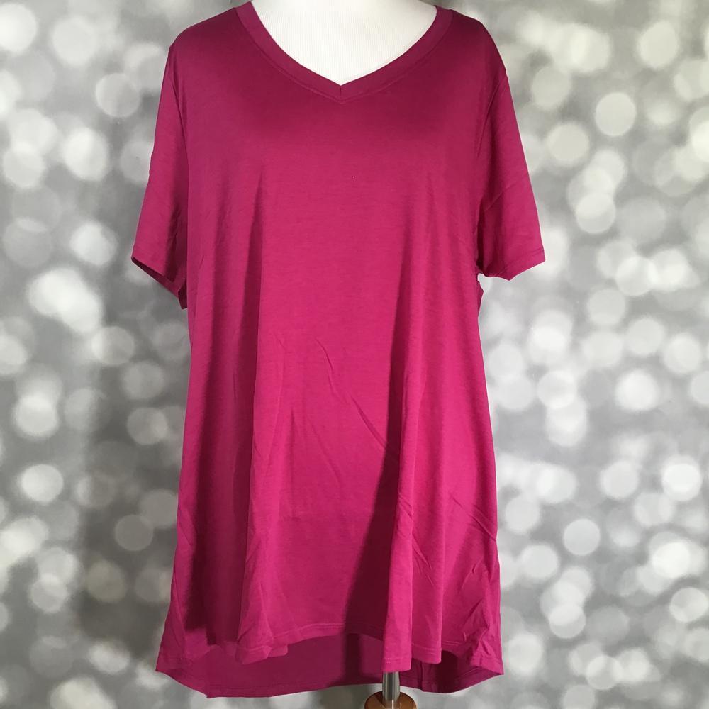 LuLaRoe Christy T in solid raspberry sangria featuring a relaxed V-neck swing silhouette displayed on a mannequin against a silver bokeh background.