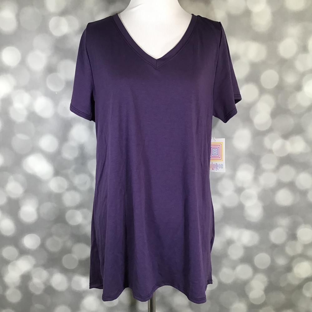 Solid deep royal plum purple LuLaRoe Christy T swing top with short sleeves and V-neckline displayed on a mannequin against a silver bokeh background.