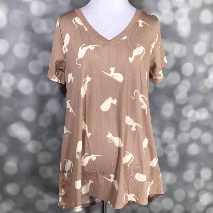 LuLaRoe Christy tee in tan color with ivory cat print, featuring a v-neckline, short sleeves, and relaxed flowy fit, displayed on a mannequin.