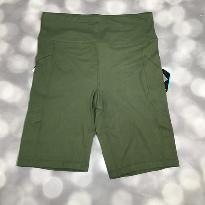 LuLaRoe Driven Shorts in solid olive green, displayed flat on a gray bokeh background. The shorts feature a high-rise waistband, side pockets, and mid-thigh length in smooth Lotus Jersey fabric.