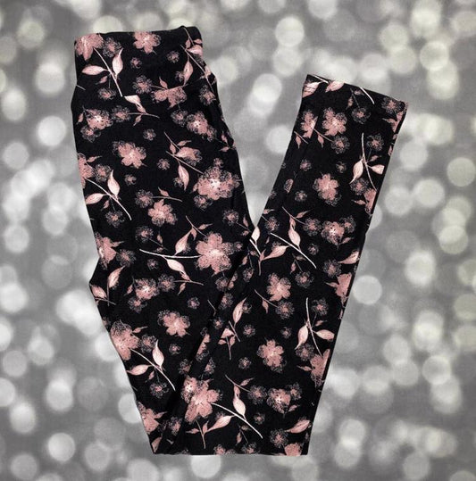 LuLaRoe leggings with soft dusty pink flowers and leaves scattered across a rich black background
