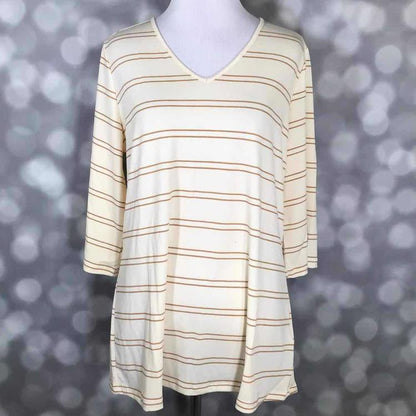 LuLaRoe Eden Top with cream base and tan double stripe horizontal pattern, V-neck with 3/4 sleeves on a blurred gray background