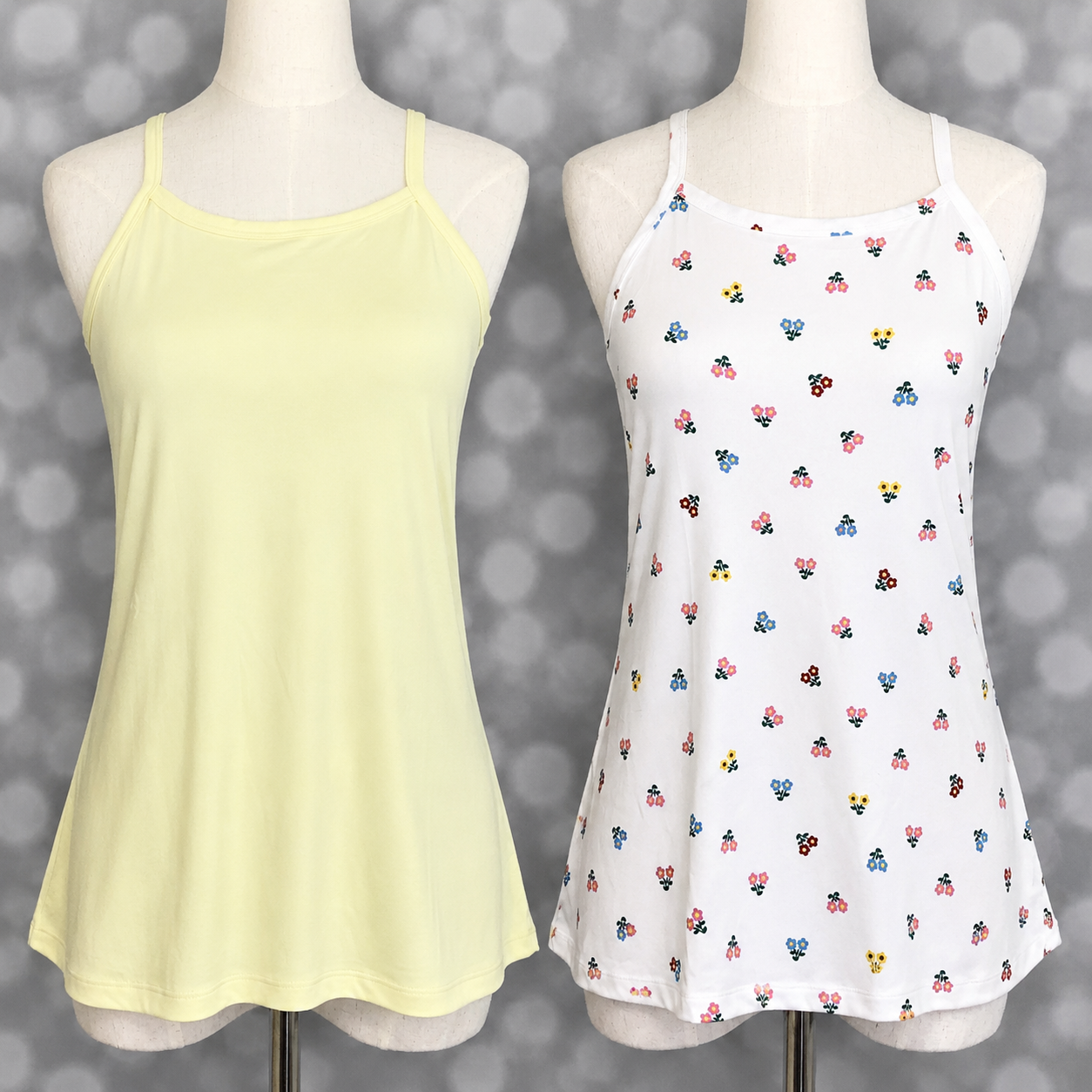Two LuLaRoe Essential camis displayed on mannequin forms against a soft gray bokeh background featuring a solid butter yellow cami and a white cami with tiny multicolor retro floral print in pink, blue, yellow, and burgundy.