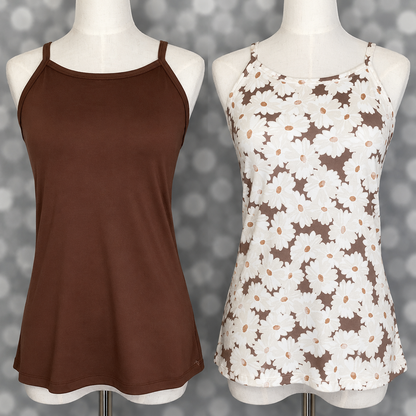 LuLaRoe Essential cami two-pack shown on mannequins featuring a solid cocoa brown camisole paired with a taupe and white oversized daisy floral print cami against a neutral gray bokeh backdrop.