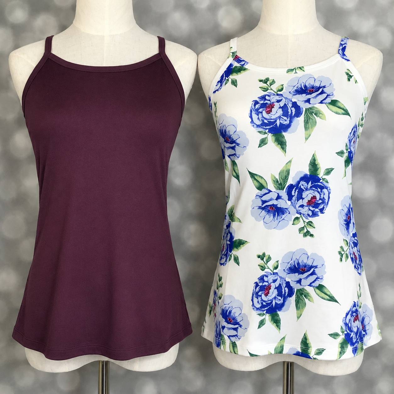 Two LuLaRoe Essential camis photographed on mannequins featuring a solid deep plum camisole and a white cami with oversized blue watercolor rose floral print and green leaves against a neutral gray studio backdrop.