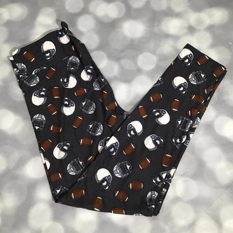 LuLaRoe leggings with brown footballs and black and white helmet print on a charcoal gray background