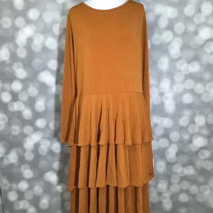 LuLaRoe Georgia Dress in solid golden caramel featuring long sleeves, a scoop neckline, and a flowing three-tiered skirt. Women's maxi dress in a warm camel brown shade designed for comfortable everyday wear, special occasions, seasonal styling, and effortless feminine fashion.