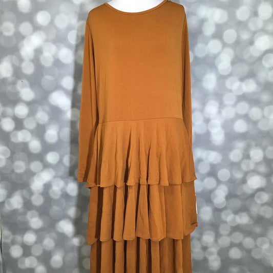 LuLaRoe Georgia Dress in solid golden caramel featuring long sleeves, a scoop neckline, and a flowing three-tiered skirt. Women's maxi dress in a warm camel brown shade designed for comfortable everyday wear, special occasions, seasonal styling, and effortless feminine fashion.