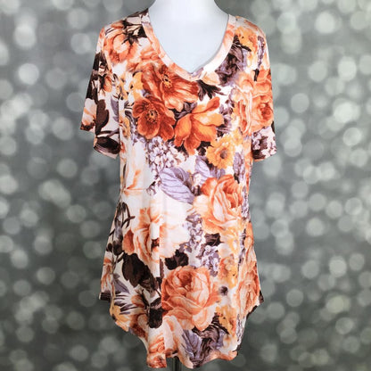 LuLaRoe Iris Tee in Autumn Rose Garden featuring peach, apricot, terracotta, and lavender floral blooms on an ivory background with a rounded v-neckline, relaxed sleeves, and tunic-length silhouette.